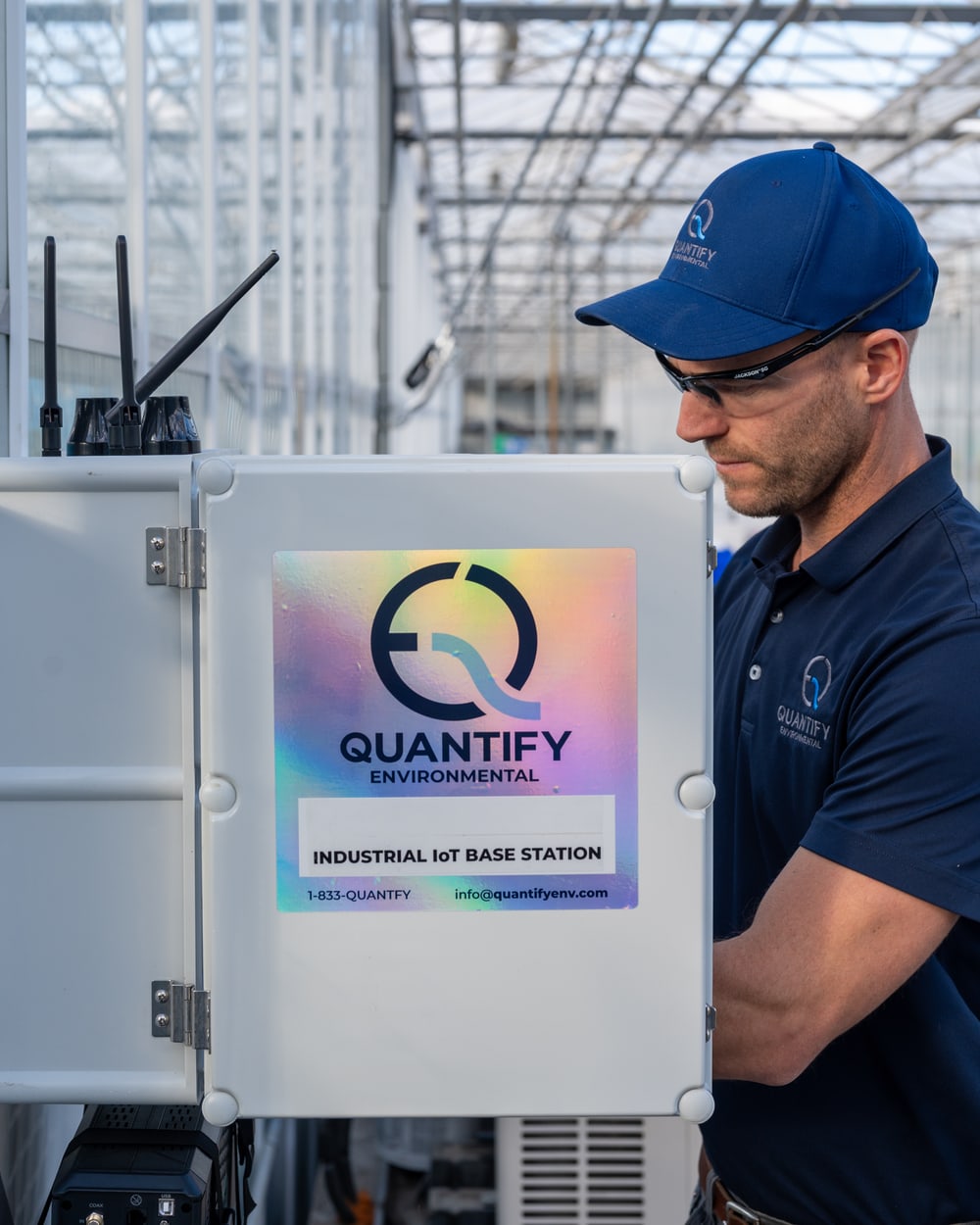 Dave Fox at an open Quantify base station enclosure in a greenhouse